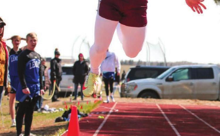 Timber Lake senior Hank Kraft leaps for a triple jump mark during the Timber Lake Invitational meet April 26. Photo by Jon Flatland