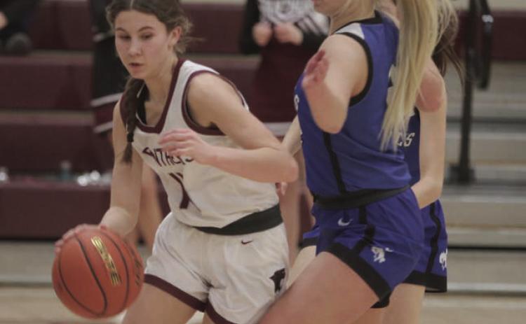 Timber Lake sophomore Natalie Lawrence dribbles past Lemmon defender Allie Kohn (right) during Region 8B tournament action last week. the Lady Panthers advanced to the SoDak 16 with a 66-53 win. Photos by Jon Flatland