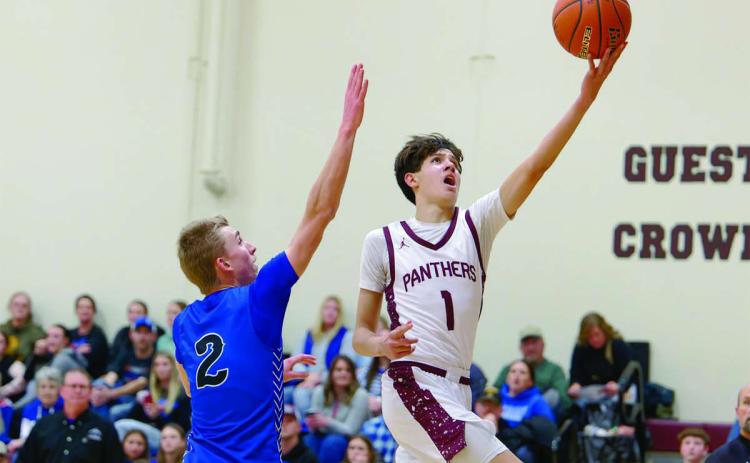 Timber Lake forward Jackson Bigger drives past Lemmon’s Drew Hetzel for a layup during the Panthers’ win over the Cowboys in the boys basketball season opener last Friday, Dec. 19. Bigger finished the contest with 13 points. Topic Photo/Marie Du Preez