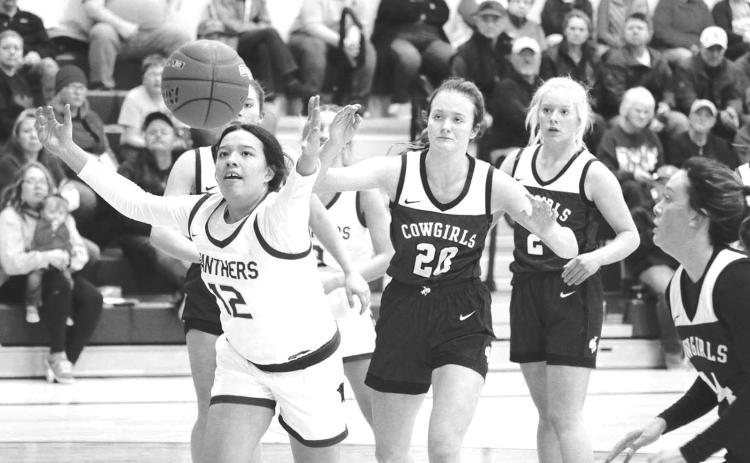Timber Lake center Kessa Bigger (12) scrambles for a rebound during action against Lemmon last Friday, Dec. 9. Looking on are Lemmon defenders (l-r) Kelly Lynch, Allie Kohn and Emily Faughn. Timber Lake claimed a 59-43 victory to improve to 2-0. Photo by Jon Flatland