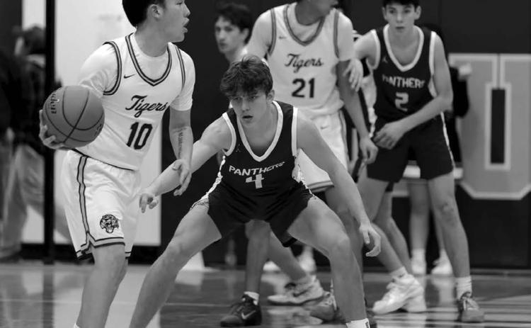 Dupree’s Tre White Wolf (10) surveys the floor while being defended by Timber Lake’s Broc Bauer. In the background, Ayden Uses Knife (21) is covered by Pete Maher (2). The Tigers knocked off the Panthers 63-60 last Tuesday, Feb. 3, for the second time in two weeks. Topic Photo/Marie DuPreez