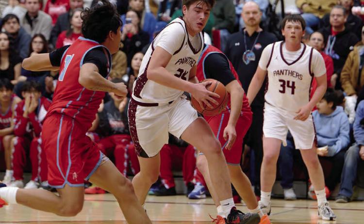 Kanton Hunt drives past a C-EB defender on his way to the hoop during the Panthers’ loss to the Braves that included 15 three-pointers. Hunt finished with a game-high and career-high 32 points. Rance Martin (34) iooks on after collecting an assist on the play. Topic Photo/Marie DuPreez