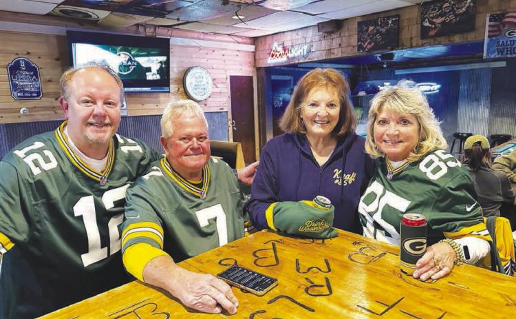 Several Green Bay/Tucker Kraft fans from Wisconsin drove to Timber Lake to watch the Packers game with other fans at The Corner Bar and Grill on Monday night. Pictured with Tucker’s grandmother, Linda Kraft (in blue), are (l-r) Steve Wikel of Waupaca, WI and Ottis and Sue Smith of Grand Chute, WI. Although Tucker is out for the season with an injury and the Packers lost to the Philadelphia Eagles 10-7, the Wisconsin fans said it was worth the 1200 mile trip.