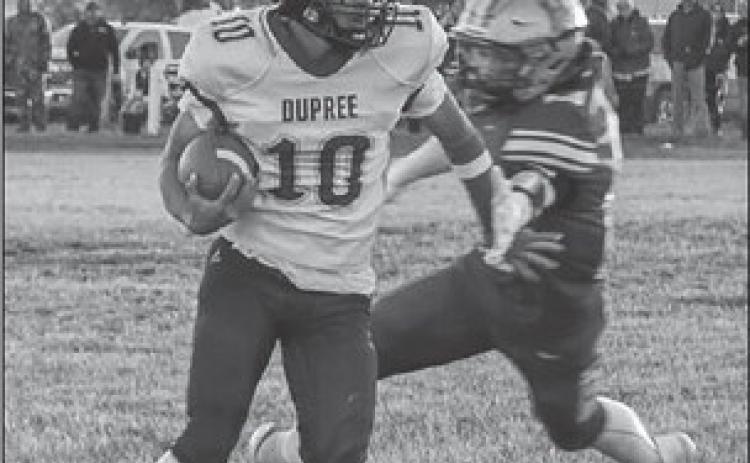 Tre White Wolf (10) spins away from a would-be tackler during Dupree’s 50-28 upset of Harding County/Bison in the first round of the State Class 9A football playoffs. White Wolf rushed for 41 yards and a touchdown in the victory. Photo by Spencer Olsen