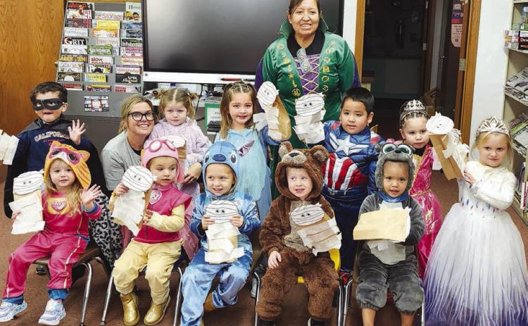 Timber Lake Head Start kids enjoyed a visit to the Dewey County Library on October 30 where they listened to a story and made a craft. Front (l-r) are Mia Linderman, Reagan Kraft, Kara Aberle, Dexter Aberle, Tomi White; middle: Antonio Loaiza-Montiel, Kacey Long, Haysley Long, Shiloh Smith, Khalil Thompson, Leyla Bullhead, Nora Serr; back: teacher Nina Schumacher.
