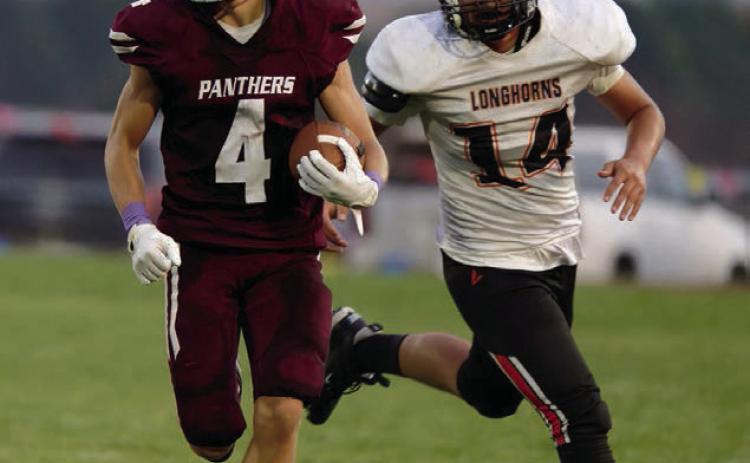 Broc Bauer (4) had a big night last Friday, catching two TD passes and racking up 300 all-purpose yards in Timber Lake’s win over the Faith Longhorns. Photo by Marie Du Preez