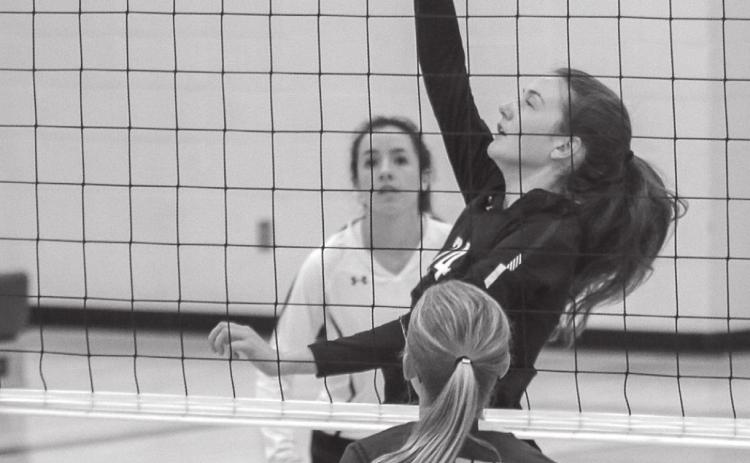 LEFT: Sara Holzer sends a spike over the net. Holzer has been contributing at the net for Timber Lake as the season has gone on. Photos by Jon Flatland