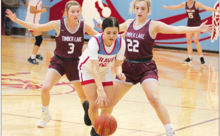 Timber Lake’s Carlie Lawrence (3) and McKenzi Vomacka (22) pressure Cheyenne-Eagle Butte’s Tiana Johnson during the Lady Panthers 56-30 win over the Lady Braves last Friday, Feb. 17, in Eagle Butte. Timber Lake closed its regular season at 14-5 and is the No. 1 seed in the Region 8B Tournament. Photo by Jon Flatland