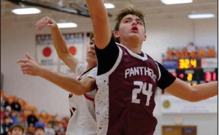 Left, Timber Lake’s Kanton Hunt (24) battles an unidentified defender for a rebound duing the Panthers ‘matchup with Mobridge-Pollockon Dec.16. Topic Photo/Marie DuPreez