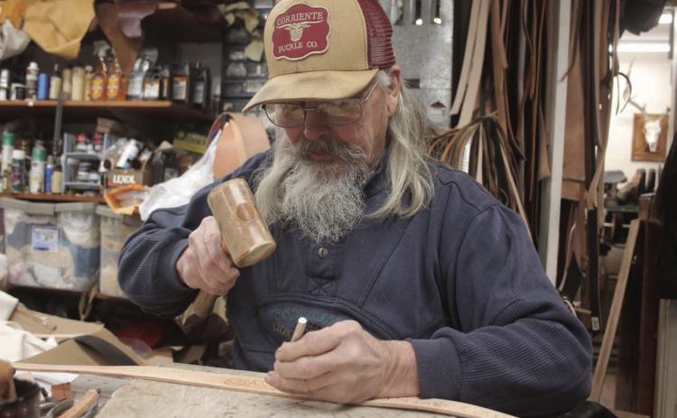 John Bachman, owner of the Eagle Butte Saddle Shop, has spent the better portion of his life working with leather. Photo by Jon Flatland