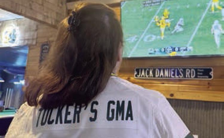 Linda Kraft, Tucker Kraft’s grandmother, watches him on the television at The Corner Bar &amp; Grill.
