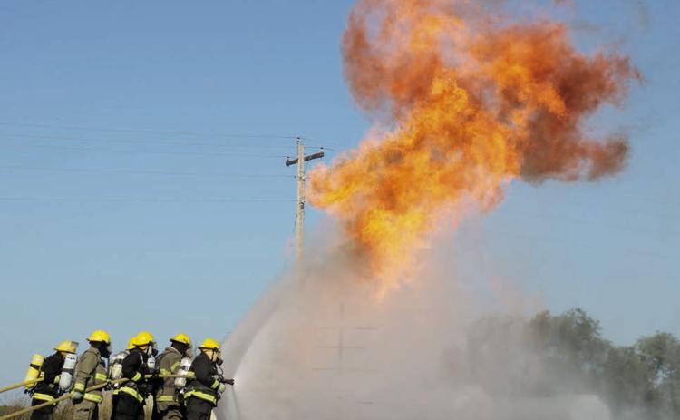 About 70 firefighters from area communities took part in a Northwest District Fire School in Isabel on Sunday, Sept. 21. Firefighters trained on handling propane fires, wildland firefighting techniques, vehicle extrication, and electrical fires and safety. Photo by Jon Flatland