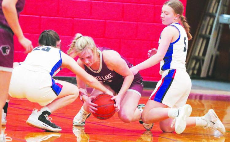 Timber Lake’s McKenzi Vomacka (center) battles North Central’s Natalie Bieber (25) and Alaina Dosch (5) for a loose ball during the Lady Panthers 59-35 win over the Thunder last Thursday, Dec. 29. Timber Lake hosts Potter County on Friday, Jan. 6, before traveling to McIntosh for a Little Moreau Conference tilt on Tuesday, Jan. 10. Photo by Jon Flatland