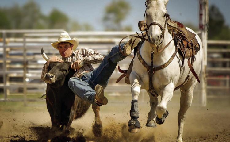 Gettin’ it done ... At left, Dupree senior Roper Eaton shows the form that won him the steer wrestling event at the Faith High School Practice Rodeo last week. No official results had been posted for the rodeo as this issue of the Topic went to press. Timber Lake will host its annual practice rodeo on Saturday, May 24, with rodeos in Lemmon and Clark slated for Memorial Day, Monday, May 26. Photo courtesy of Chuck Miner