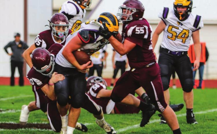 Panther defenders AJ Lindskov (55) and Thane Keller (20) team up to stop Wolverine runner Brenden Begeman during their contest in Timber Lake on Sept. 3. Photo by Jon Flatland