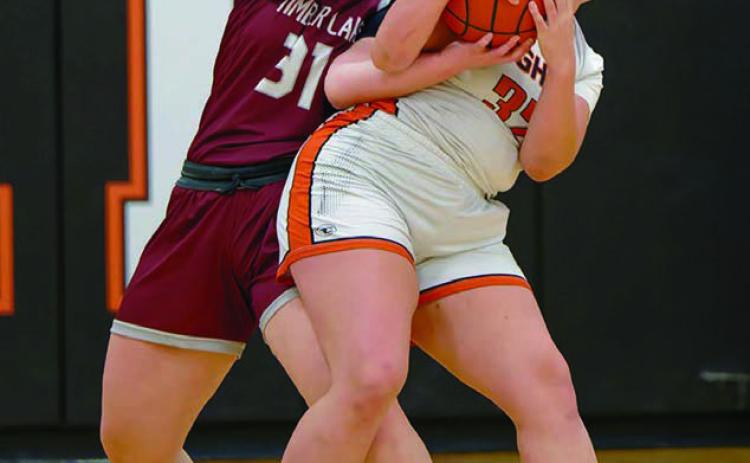Kate Biegler (31) of Timber Lake wrestles for control of a rebound with Faith’s Shaie Veit in Faith last week. The Lady Panthers claimed their first win of the season with a thrilling 64-63 overtime victory. Biegler scored 12 points in the effort. Topic Photo by Marie DuPreez