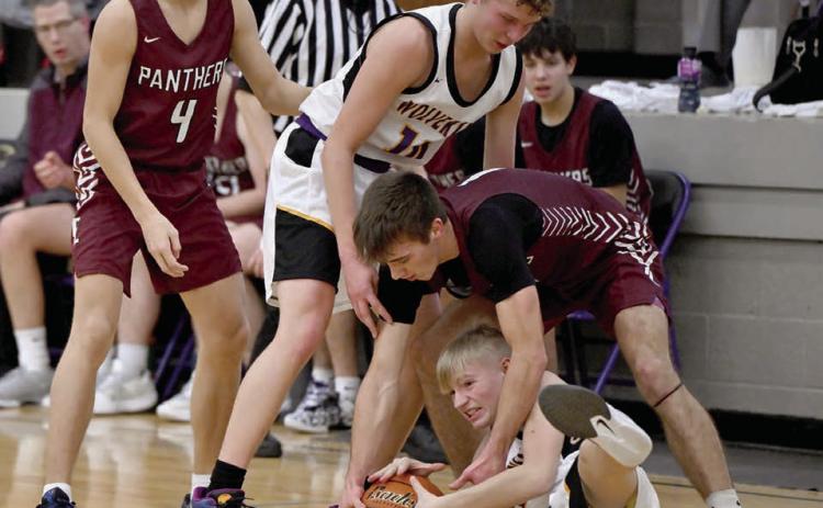 Timber Lake’s Gavin Farlee fights an unidentified Herreid-Selby player for control of a loose ball during the Panthers’ 58-29 win over the Wolverines last week. Looking on are Broc Bauer (4) and Herreid-Selby’s Jared Weisbeck (10). Photo by Marie DuPreez
