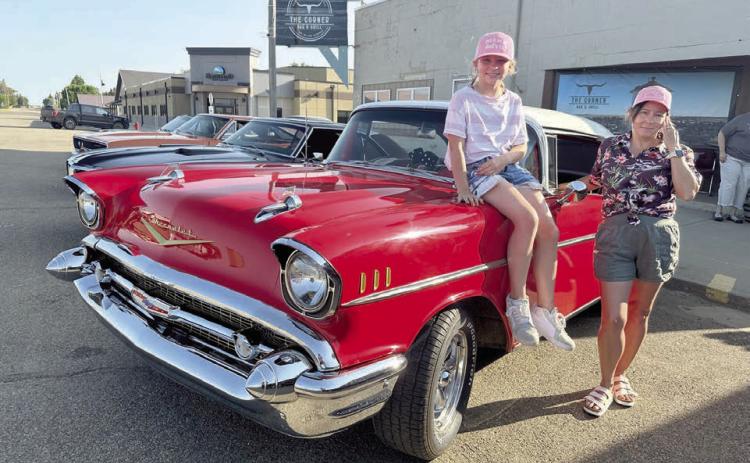 Marie Gross and her daughter, Sophia, were at the Rods n’ Reels event at The Corner Bar &amp; Grill on Saturday, June 21, showing off their ride - beautiful 1957 Chevrolet with red and black interior. The vehicle is owned by their husband and father Richard Gross, who is one of the organizers of the event. Photos by Kathy Nelson