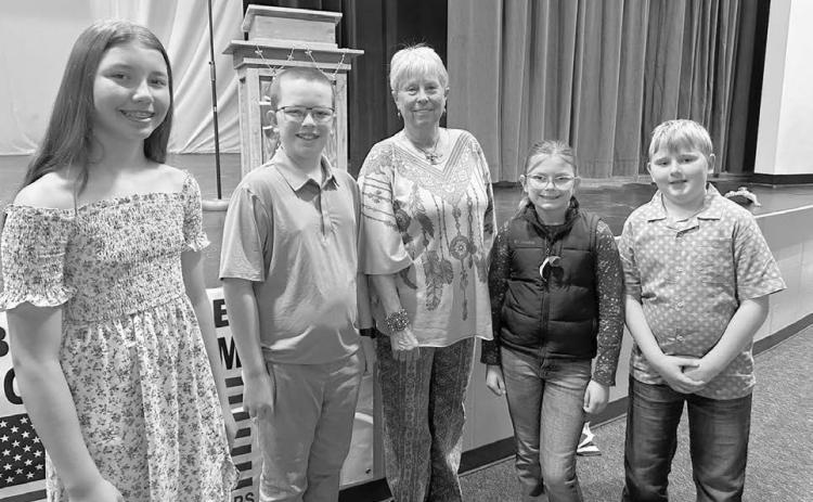 Johny Weber (middle) was the guest speaker at Timber Lake’s Memorial Day program on May 26. Students who read their Americanism essays and poems were (l-r): Brinley Mowrer, Garrett Nilson, Stella Nilson, and Isaac Schweitzer.