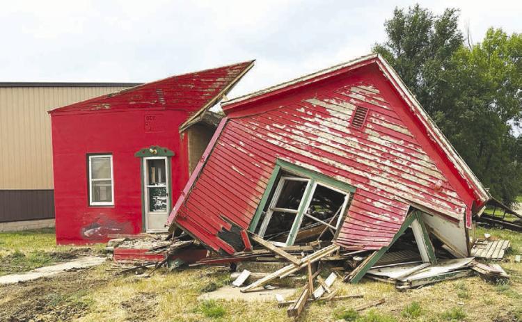 LEFT: Part of the former Dewey County Jail building at the corner of 9th and E streets in Timber Lake, now owned by John Linderman, is being demolished.