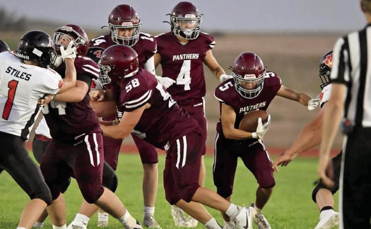 Rance Gross (5) shoots for a gap in the line during Timber Lake’s football season opener against Ipswich last Friday, Aug. 22. Creating a hole for the sophomore running back are Mason Bickel (54) and Xander Keller (58) while Broc Bauer (4) looks on. Gross finished with 11 yards on the night as the Tiger defense kept the Panthers in check. Photo by Marie Du Preez