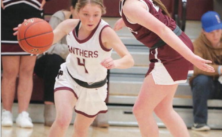 Timber Lake junior guard Kenlea Heck dribbles past McIntosh defender Josie Campbell to start a fast-break during first-round action of the Little Moreau Conference Girls’ Basketball Tournament. The top-seeded Lady Panthers were handed their first loss of the season in the semifinal round by Lemmon. Photo by Jon Flatland