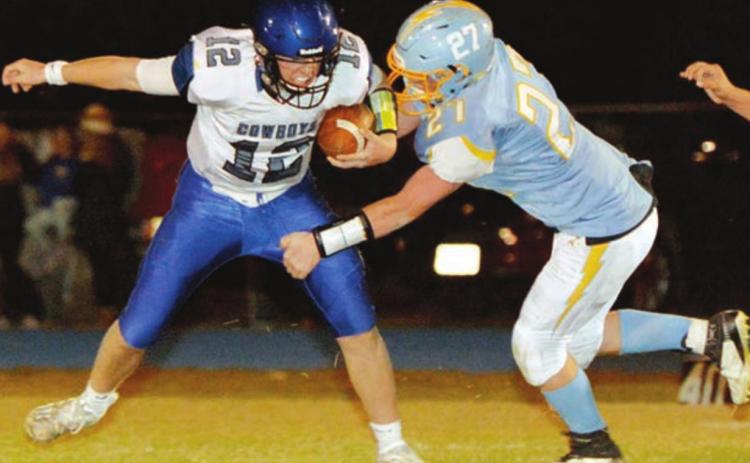 Lemmon/McIntosh senior QB Cody Thompson is pressured by Hamlin’s Michael Stevenson during their state semifinal round game. Photo by Roger Merriam, Watertown Public Opinion