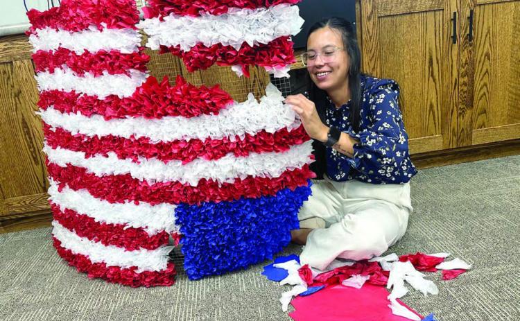 Sierra Eagleman stuffs tissue paper in a screen for Western Dakota Bank’s float which will appear in the Timber Lake and Isabel parades the next two Saturdays. See details about both celebrations inside this issue. Photo by Kathy Nelson