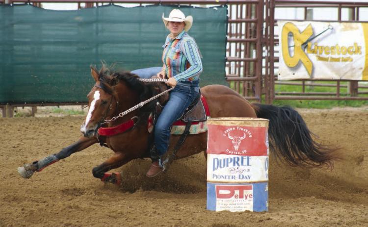 Hope Kiel of Glenham horse dips her horse around a barrel during the Senior Girls Barrels event at the 64th annual Ziebach County 4-H Rodeo in Dupree on Saturday, July 13. A second day of competition was cancelled due to storm damage at the Dupree Rodeo Grounds. Check out the Topic Facebook page for more Jr. and Sr. Girls Barrels and Poles photos. Photo by Jon Flatland