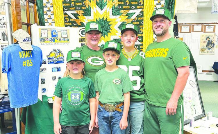 The Krueger family from Arbor Vitae, Wisconsin visited Timber Lake last week to get a look at Tucker Kraft’s hometown. They are friends of Cody and Tracy Maher and Terry Renderneck and were on their way to Yellowstone. They came dressed in Packers attire but stopped at Dakota Image to pick up some more. They saw the Tucker Kraft exhibit at the Museum (above) and had lunch at The Corner Bar &amp; Grill.