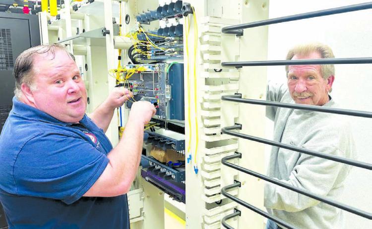 Mike Ganje, central office supervisor for the CRST Telephone Authority (left) and Larry Mroczkowski, network engineer with Calix, were at work on Monday at the facility at Timber Lake which is the “heart and brains” of the system bringing high speed internet to rural Timber Lake. Photo by Kathy Nelson