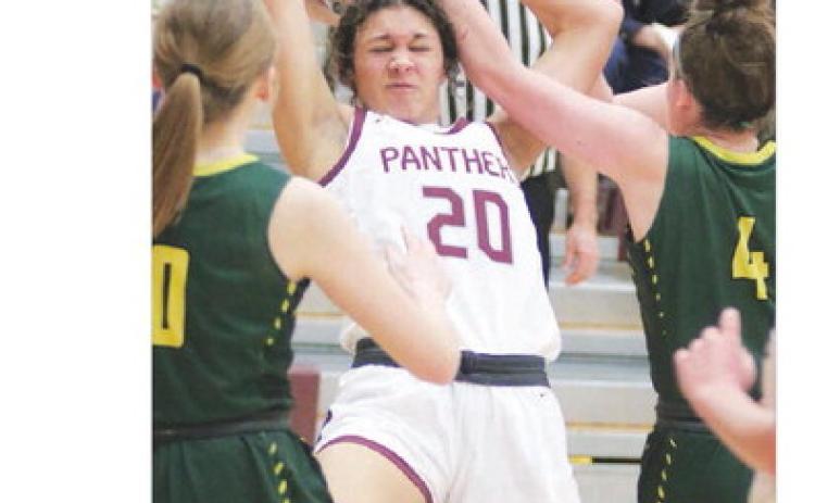 Sophomore forward Jasmine Nash (20) is fouled while pulling down a rebound during action against Aberdeen Roncalli last Friday, Jan. 27. The visiting Crusaders upset the No. 4 ranked Lady Panthers 62-49. Photo by Jon Flatland