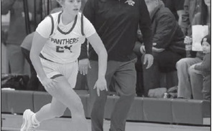 Maddy Hermes brings the ball upcourt while Timber Lake coach Tuffy Thompson gives her instructions during Panther basketball action against new Underwood. Topic Photo/Marie DuPreez
