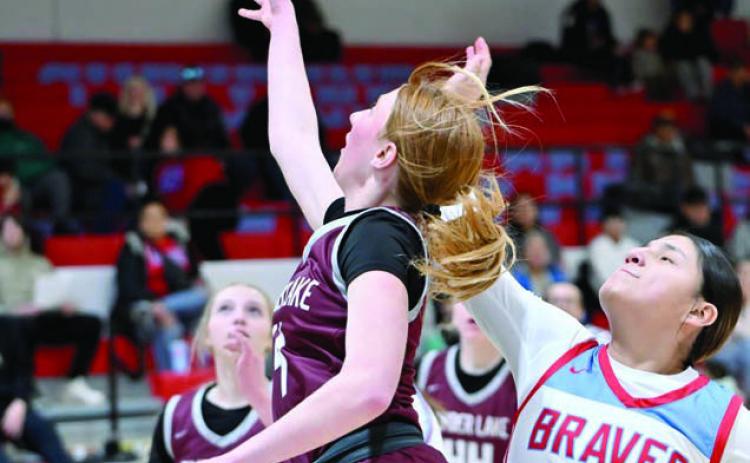 Junior Sara Keller lays a shot up while being defended by Koree Buffalo Halfrib of Cheyenne-Eagle Butte during the Lady Panthers’ loss to the Braves last week (see Page 9). Timber Lake took on Faith in the first round of the Region 8B Tournament on Tuesday evening as this issue of the Topic was going to press. Photo by Marie DuPreez