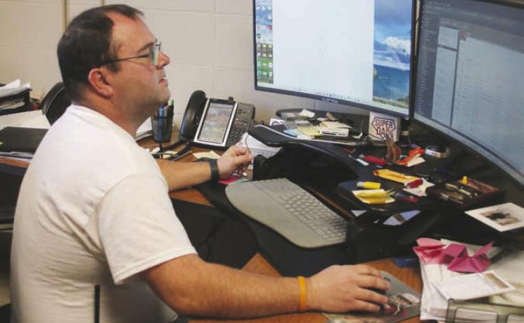 Timber Lake School IT Director Joel Schweitzer looks over plans for the $120,000 replacement of internet components aimed at keeping the district up-to-speed on the information superhighway. Photo by Jon Flatland