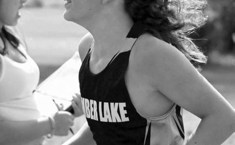 The signature long locks of Timber Lake seventh grader Mason Kraft (right) were blowing in the breeze last Thursday at the C-EB Cross Country Invitational. Kraft, competing in his first varsity race, posted a time of 22:19.00 to land 17th overall. Photo by Jon Flatland