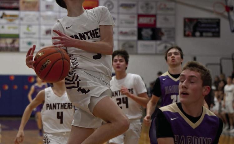Panther guard Braden Lawrence loses his grip on the basketball while driving to the hoop on a layup attempt during Timber Lake’s win over Harding County in the LMC Tournament. Defending on the play is Shawn Glines of Harding County. Photo by Marie DuPreez